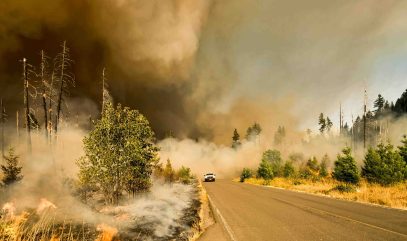 Truck fleeing a forest fire - photo by Marcus Kauffman