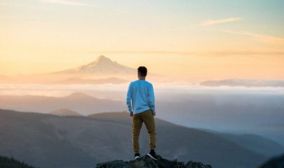 Live Your Values - Young man on a mountain peak