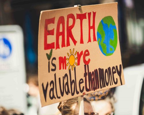 Sign that says, "Earth is more valuable than money."